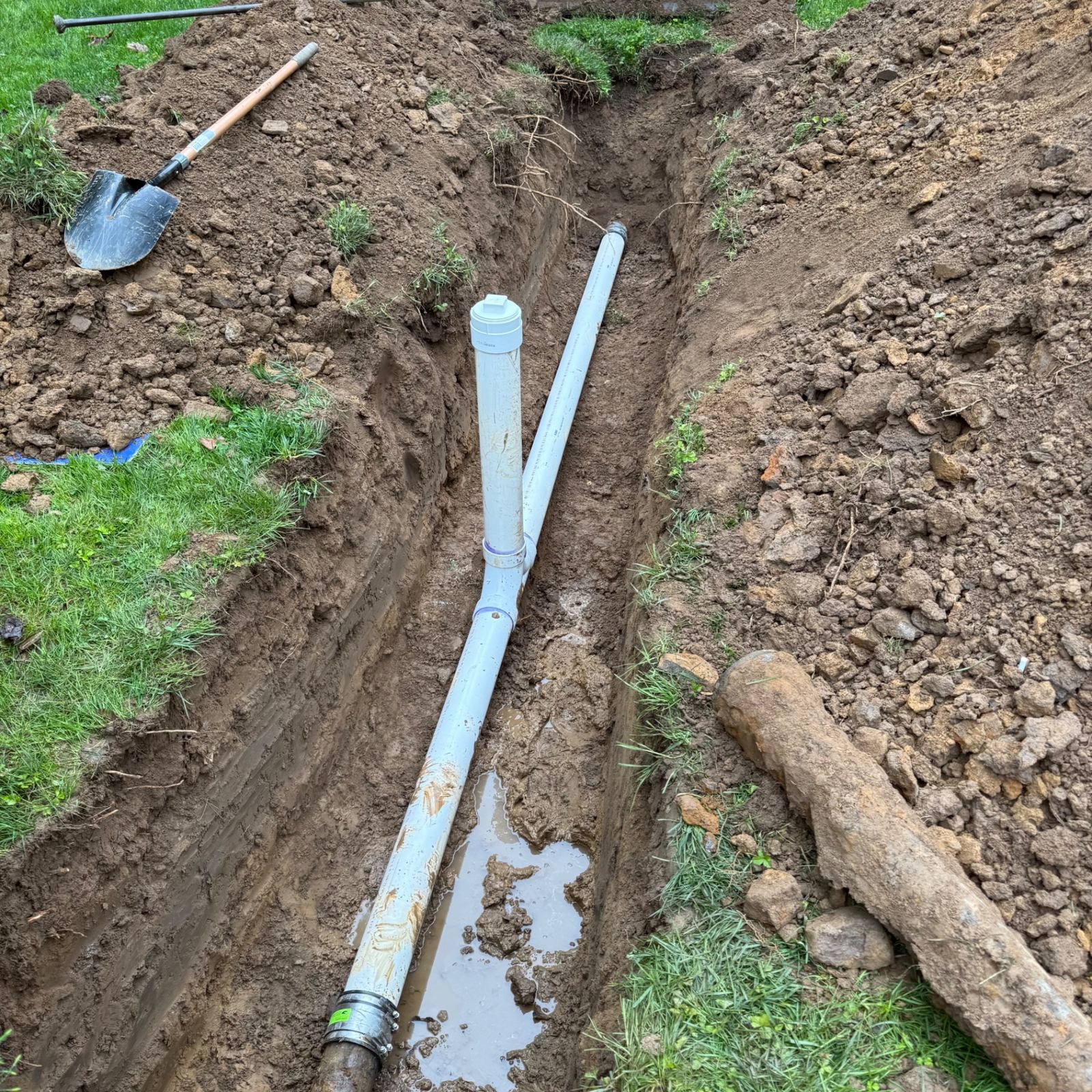 Sewer line excavation and replacement in progress